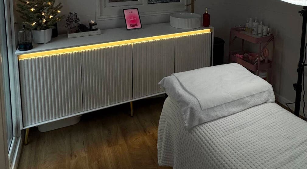 Calm treatment room at Electra Skin, Upton, England, GB, with a cozy bed and ambient lighting.