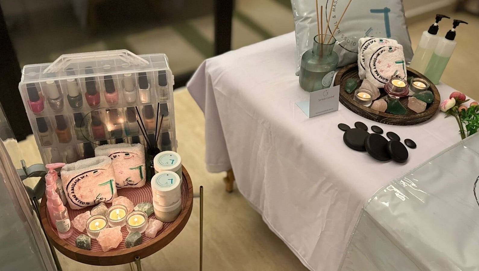 Relaxing spa setup at Gloss Nail & Massage Spa (Home Service), Riyadh with candles and massage stones.