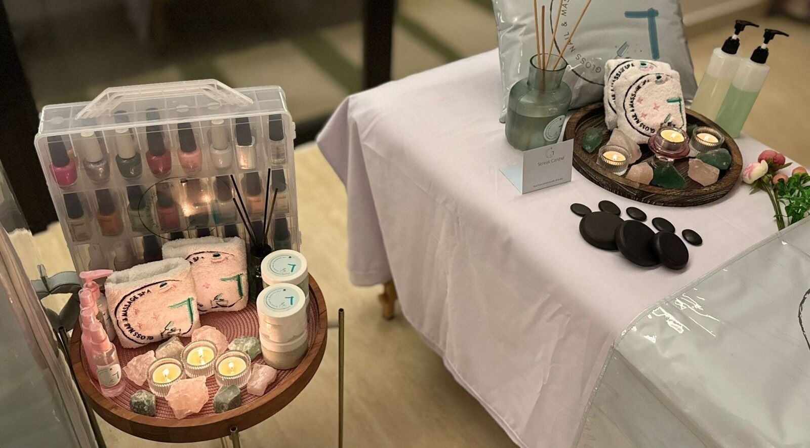 Relaxing spa setup at Gloss Nail & Massage Spa (Home Service), Riyadh with candles and massage stones.