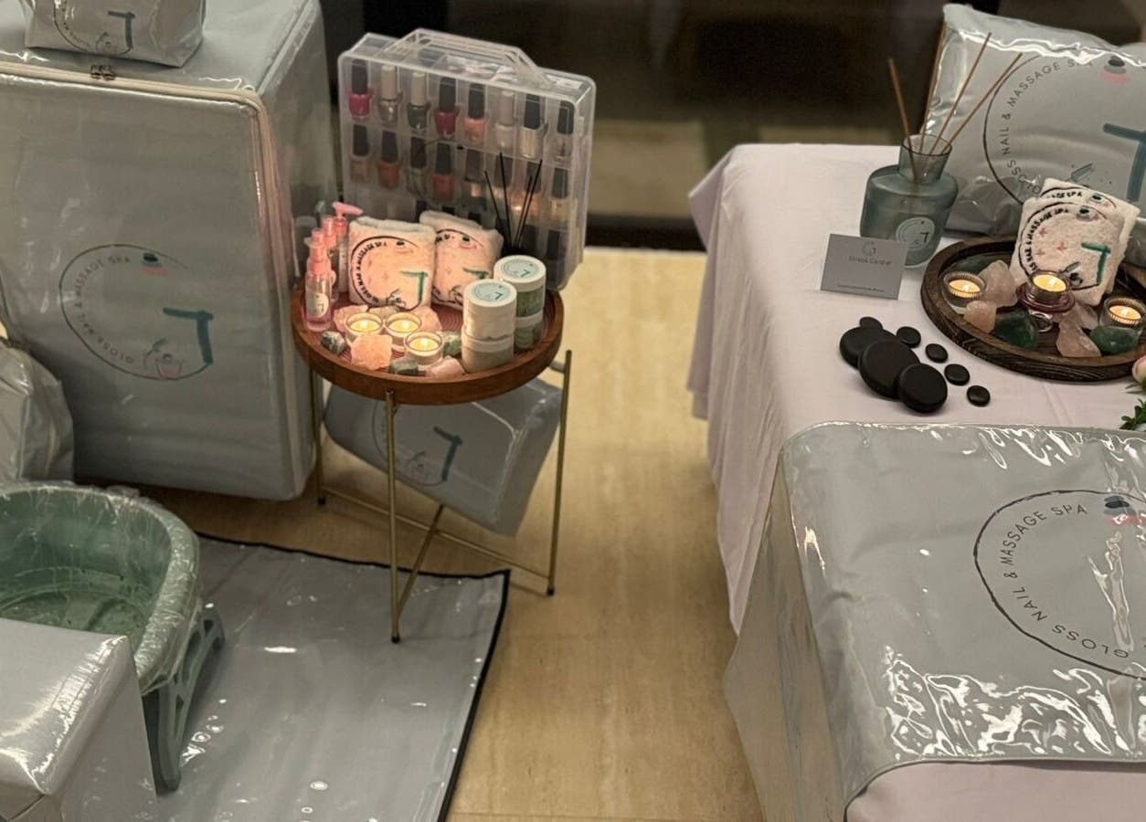 Luxurious setup at Gloss Nail & Massage Spa (Home Service), Riyadh, with candles, massage stones, and spa essentials.