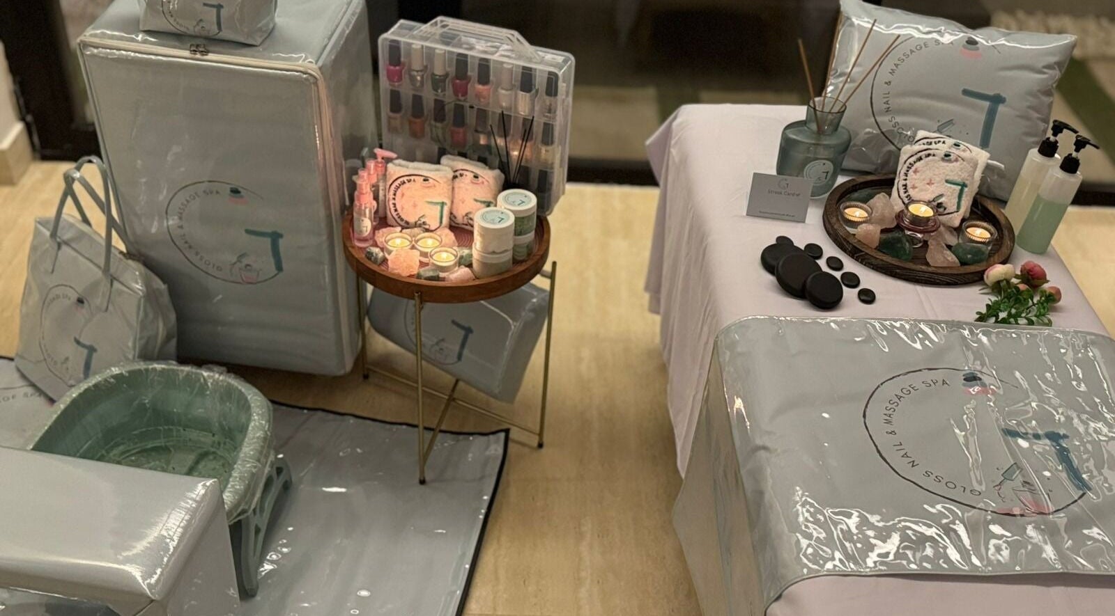 Luxurious setup at Gloss Nail & Massage Spa (Home Service), Riyadh, with candles, massage stones, and spa essentials.