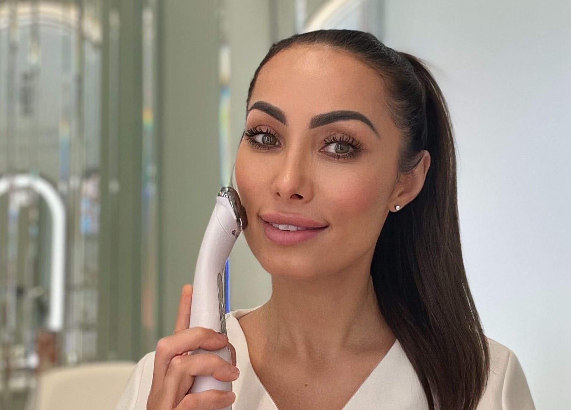 Beauty therapist with device at LOVESTETIC, Abingdon, England, GB, showcasing radiant skin treatment.