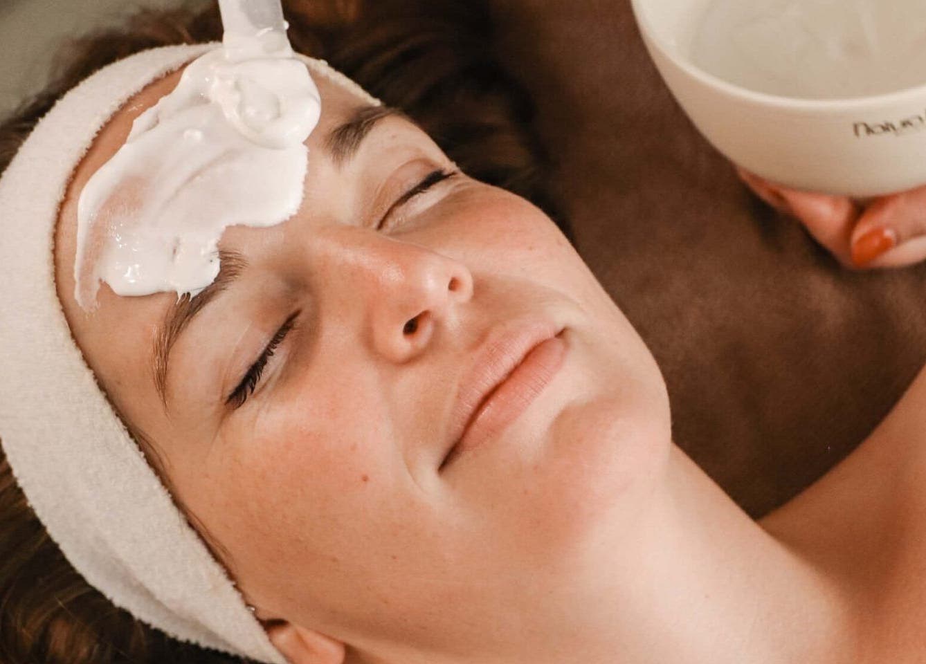 Relaxed woman receiving a facial treatment at LOVESTETIC, Abingdon, England, GB.