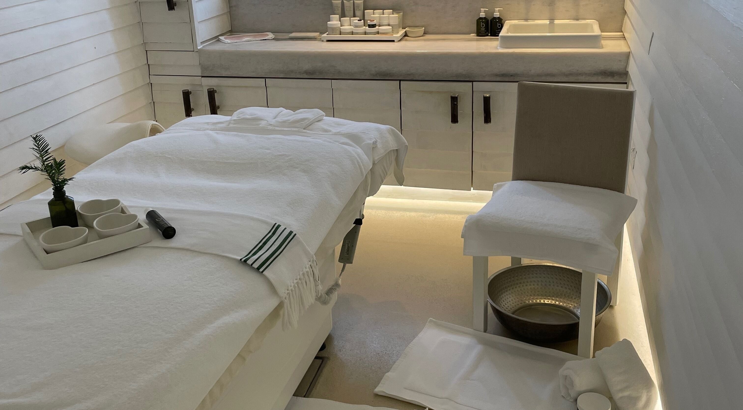 Relaxing spa room at LOVESTETIC, Abingdon, England, GB, featuring elegant treatment table and skincare products.