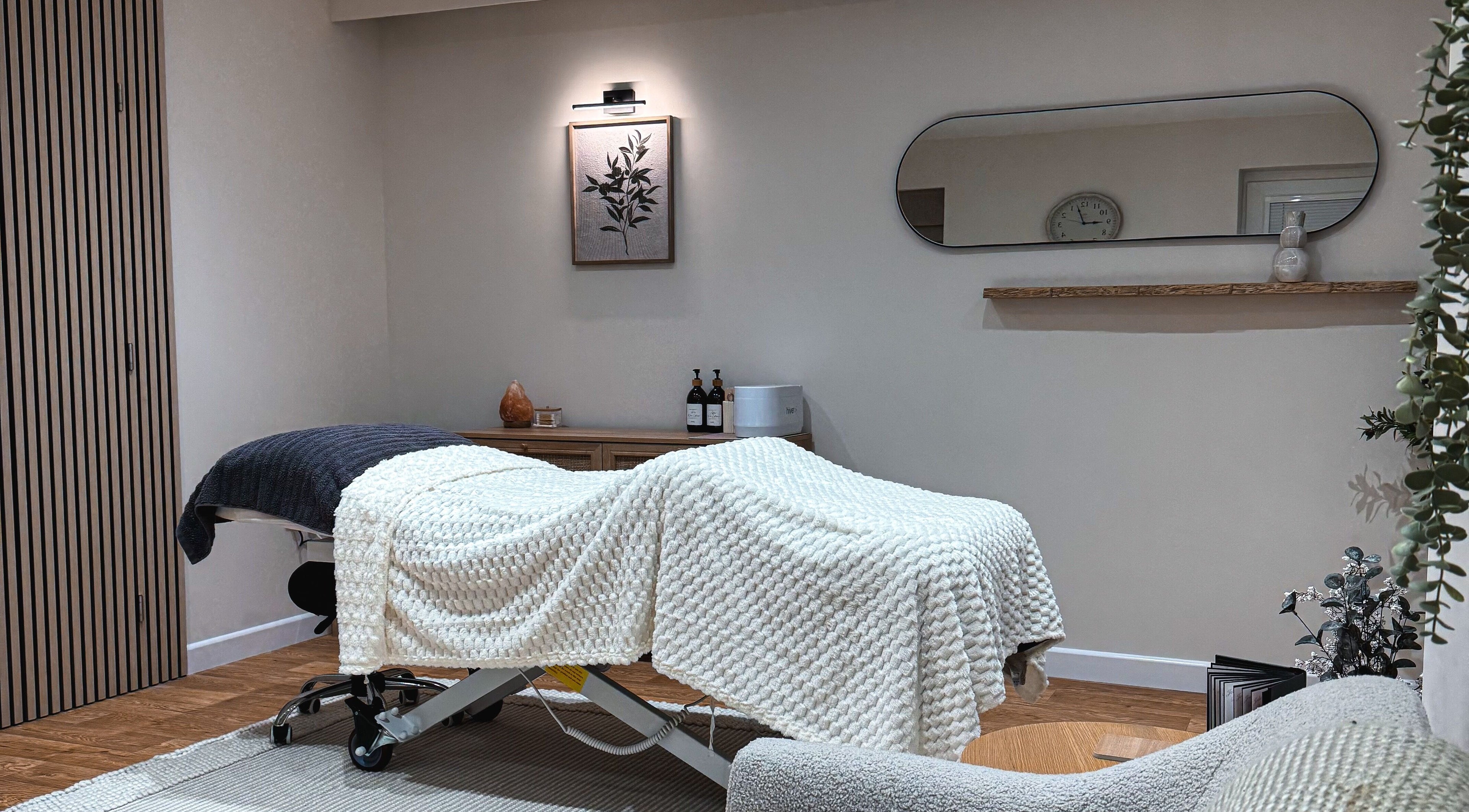 Spa room at Elegant Beauty, Midsomer Norton, England, GB, with cozy therapy bed and serene decor.