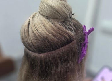 Blonde hair prepped for styling at Lahera Hair Co, South Mackay, Queensland, AU. Purple clips secure sections.