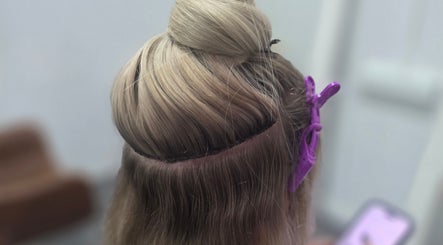Blonde hair prepped for styling at Lahera Hair Co, South Mackay, Queensland, AU. Purple clips secure sections.