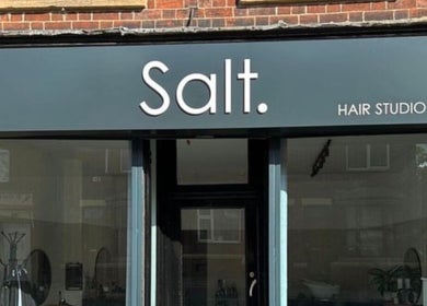 Exterior of Izzy Ferguson hair studio in Ilkeston, England, GB showcasing modern signage.