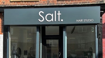 Exterior of Izzy Ferguson hair studio in Ilkeston, England, GB showcasing modern signage.