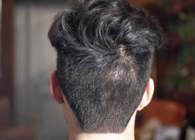 Back view of a stylish men's haircut at The Livingroom Oxford, Oxford, England, GB.