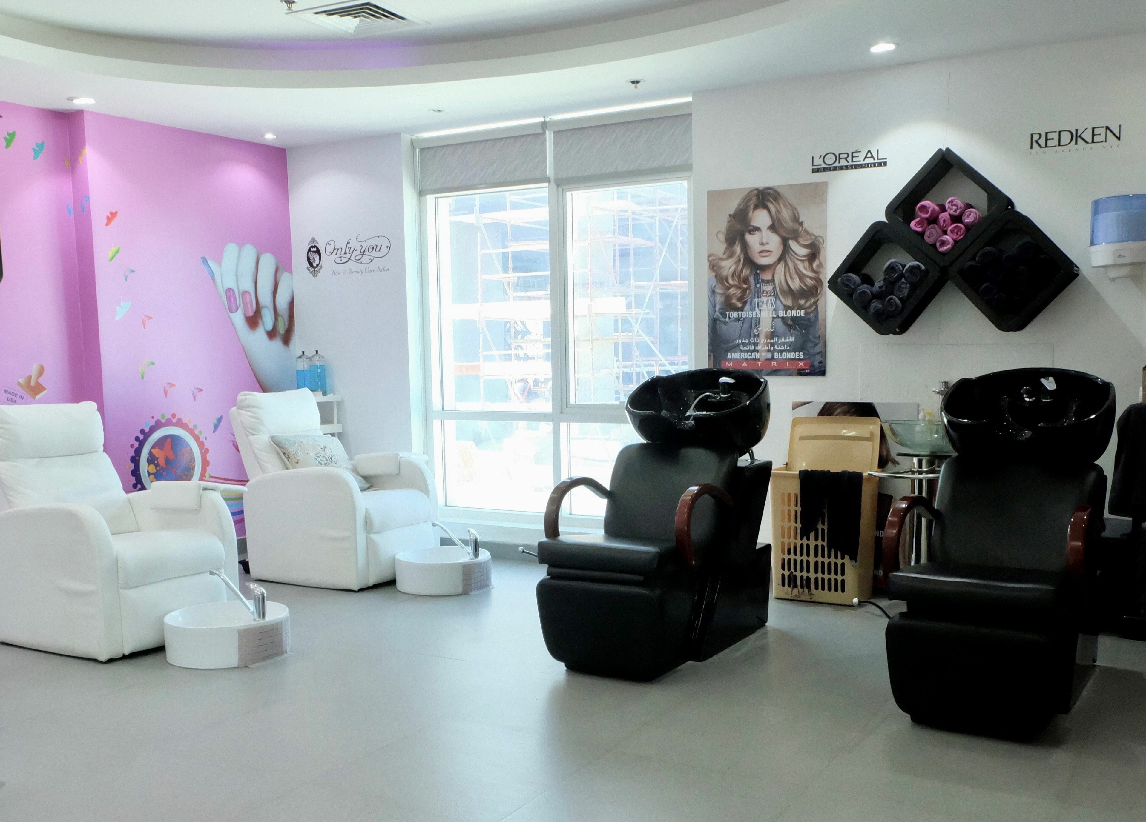 Sophisticated interior of Only You Salon in Dubai, AE, featuring plush chairs and styling stations.