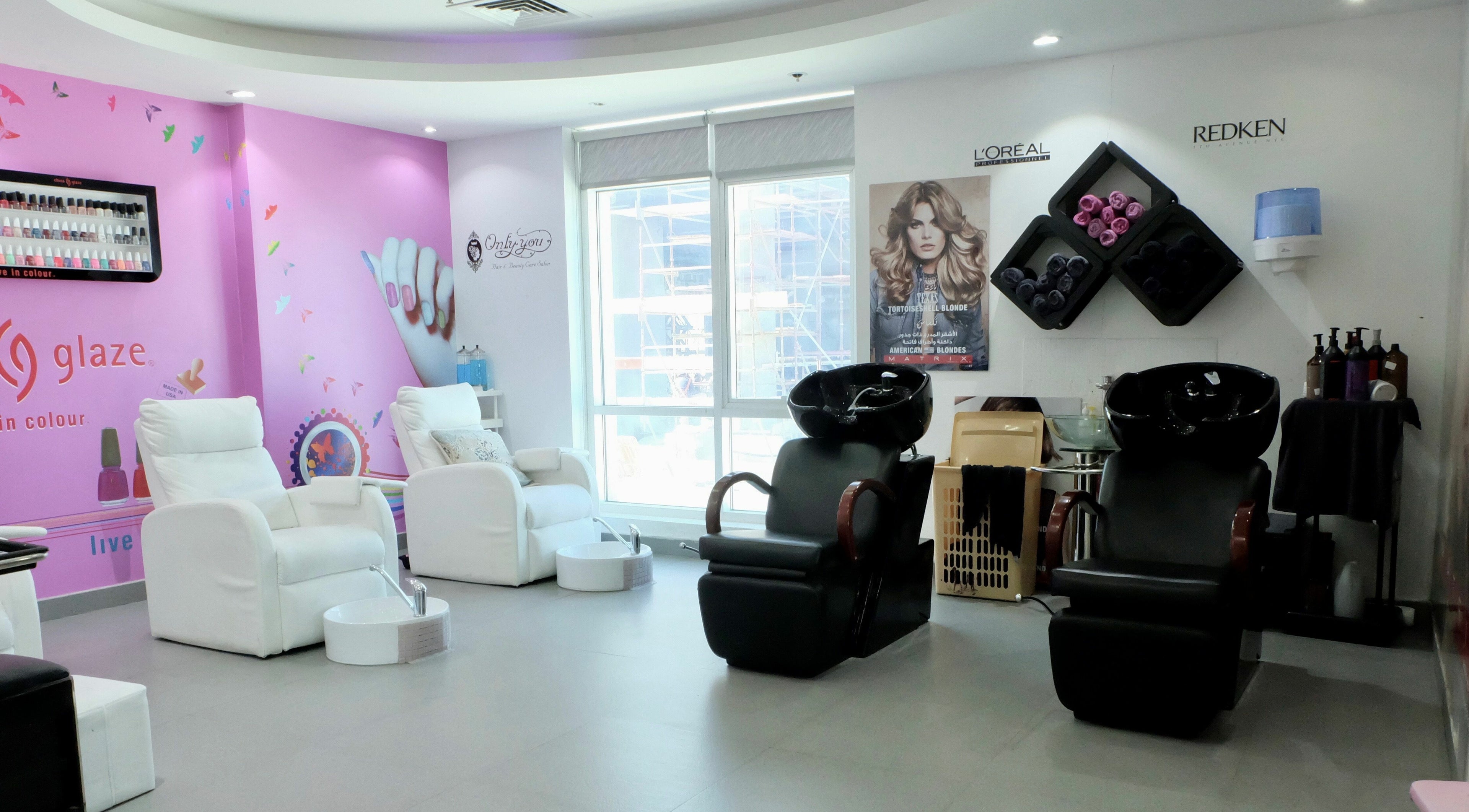 Sophisticated interior of Only You Salon in Dubai, AE, featuring plush chairs and styling stations.