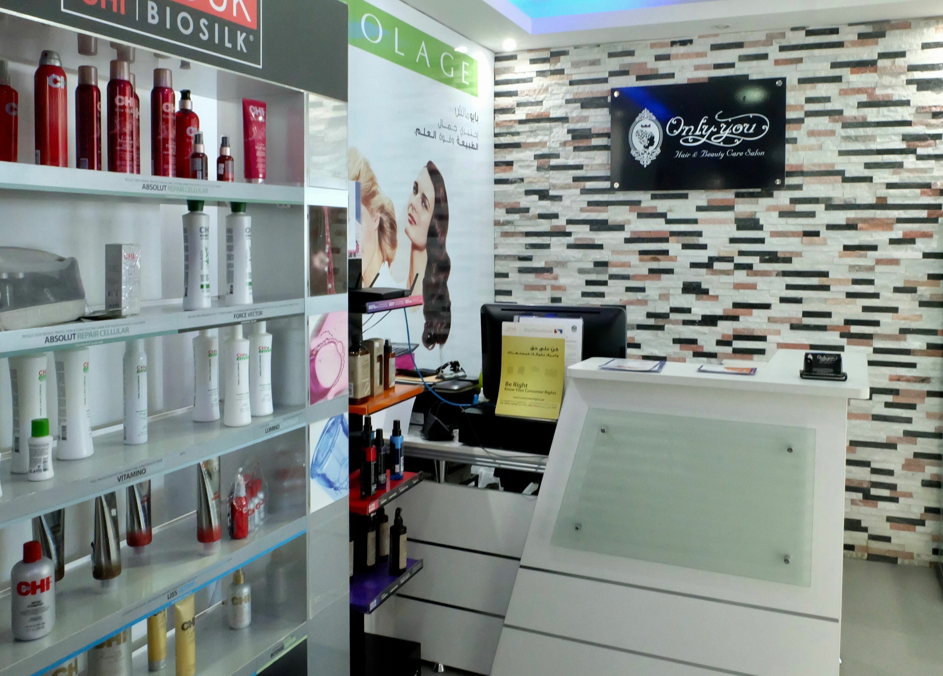 Reception area of Only You Salon in Dubai, AE showcasing hair products and stylish decor.