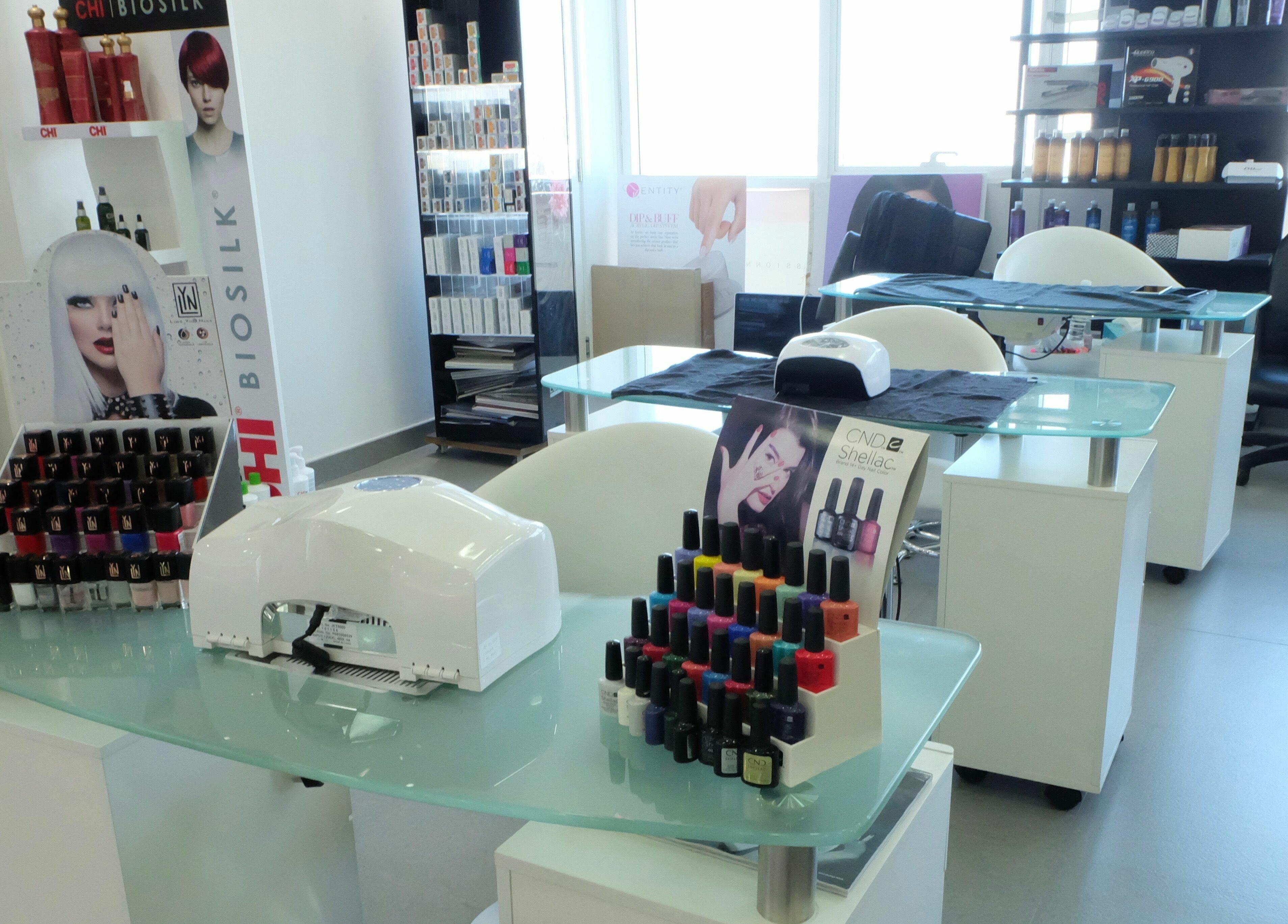 Manicure stations at Only You Salon in Dubai, AE featuring colorful nail polish displays and modern decor.