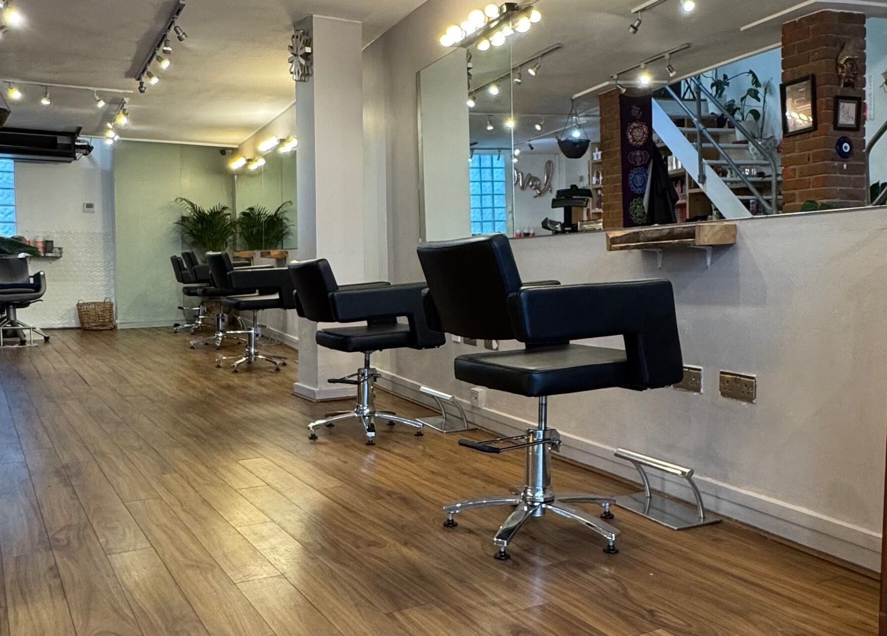 Elegant interior of The Studio by Marco Dias in Dublin, County Dublin, IE featuring sleek salon chairs and mirrors.