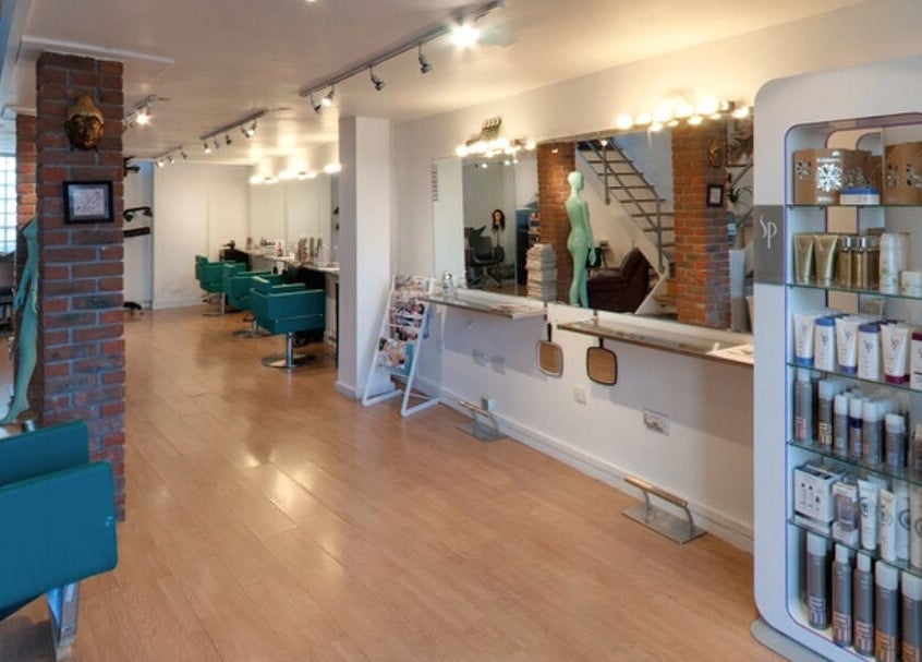 Modern salon interior at The Studio by Marco Dias in Dublin, County Dublin, IE with styling chairs and product display.