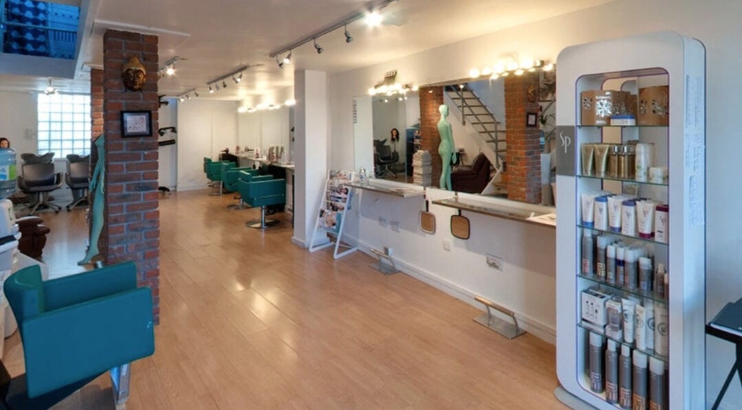 Modern salon interior at The Studio by Marco Dias in Dublin, County Dublin, IE with styling chairs and product display.