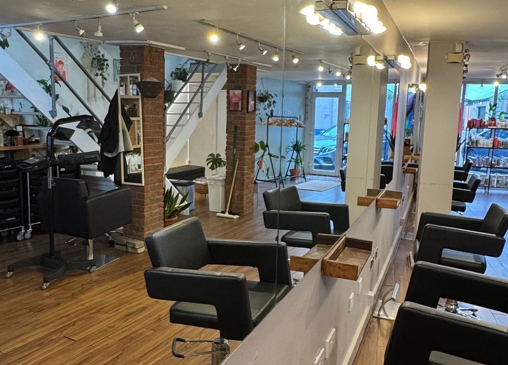 Modern salon interior at The Studio by Marco Dias, Dublin, County Dublin, IE with stylish black chairs and bright lighting.