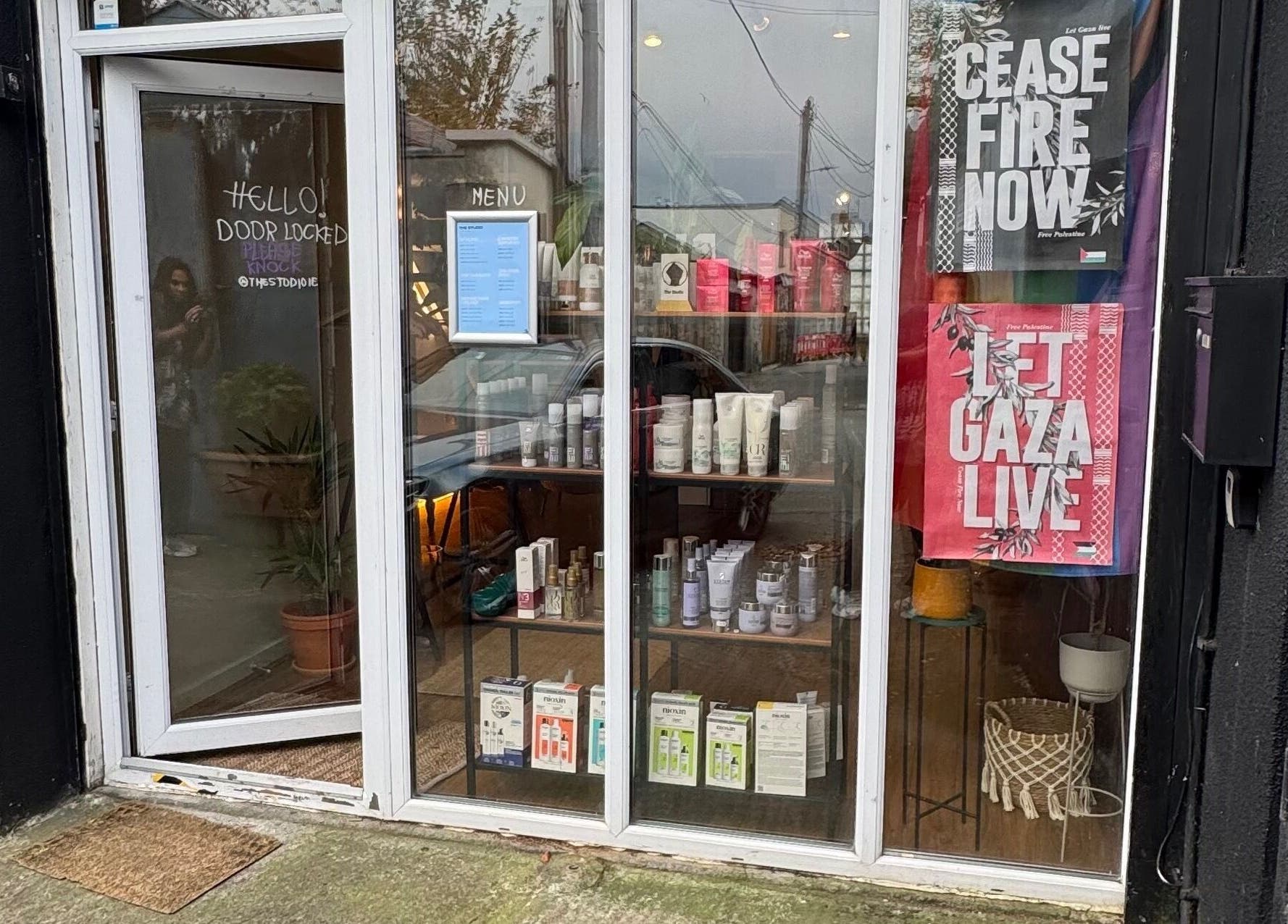 Front entrance of The Studio by Marco Dias, Dublin, County Dublin, IE, displaying beauty products through glass.