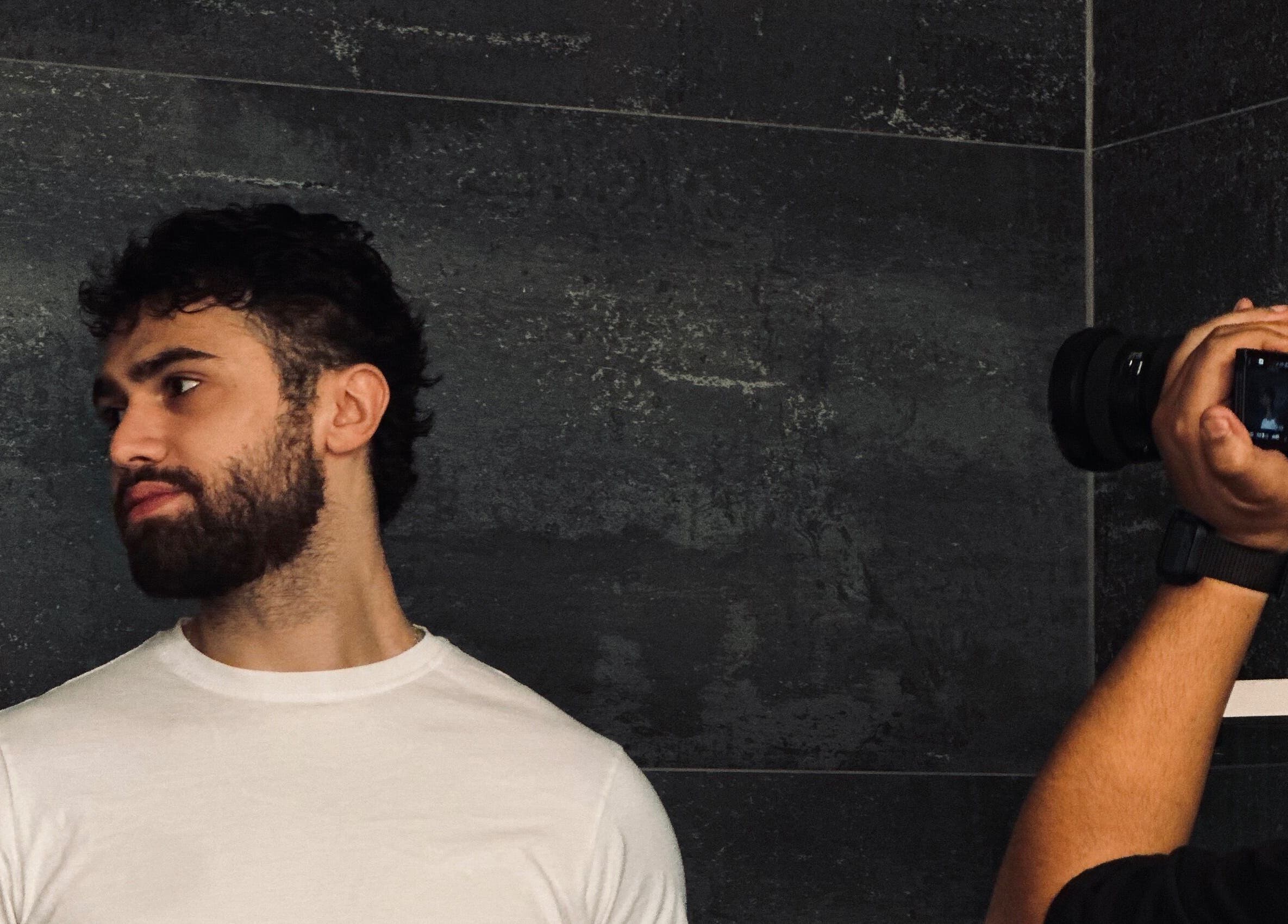 Man being photographed at Le Coupe - لي كوب, Amman, Amman Governorate, JO.
