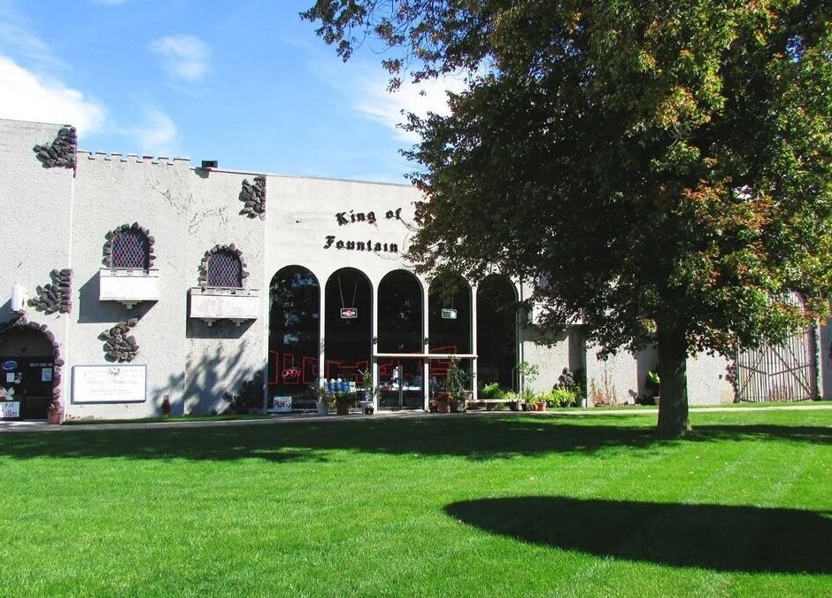 Outside view of Palace of Wellness Salon and Spa in North Webster, Indiana, US, featuring lush greenery.