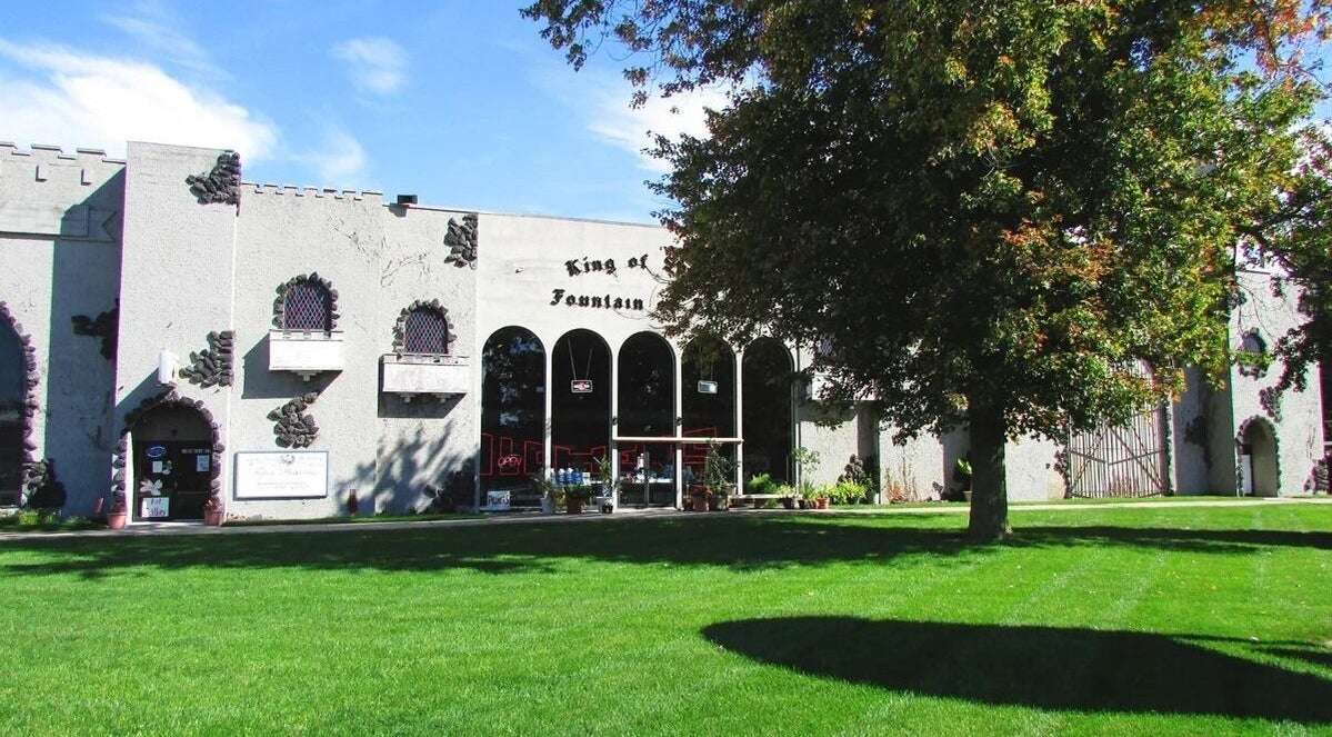 Outside view of Palace of Wellness Salon and Spa in North Webster, Indiana, US, featuring lush greenery.