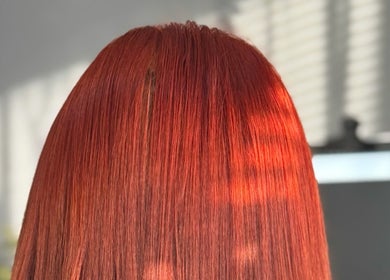 Vibrant red hair styled at La Bella Hair Extensions & Beauty, Wakefield, England, GB under natural light.