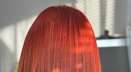 Vibrant red hair styled at La Bella Hair Extensions & Beauty, Wakefield, England, GB under natural light.