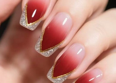 Elegant nail art with red ombre and glitter detail at Aria Nail, Massage & Head Spa, Fairfax, Virginia, US.