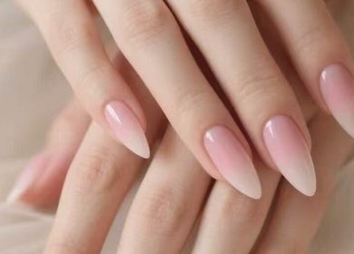 Manicured hands with pink ombre nails at Aria Nail, Massage & Head Spa in Fairfax, Virginia, US.