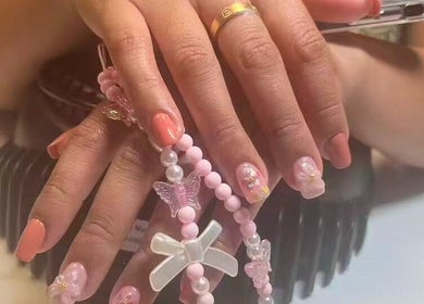 Stylish nail art with beaded accessories at Unique Nails & Head Spa, Fairfax, Virginia, US.
