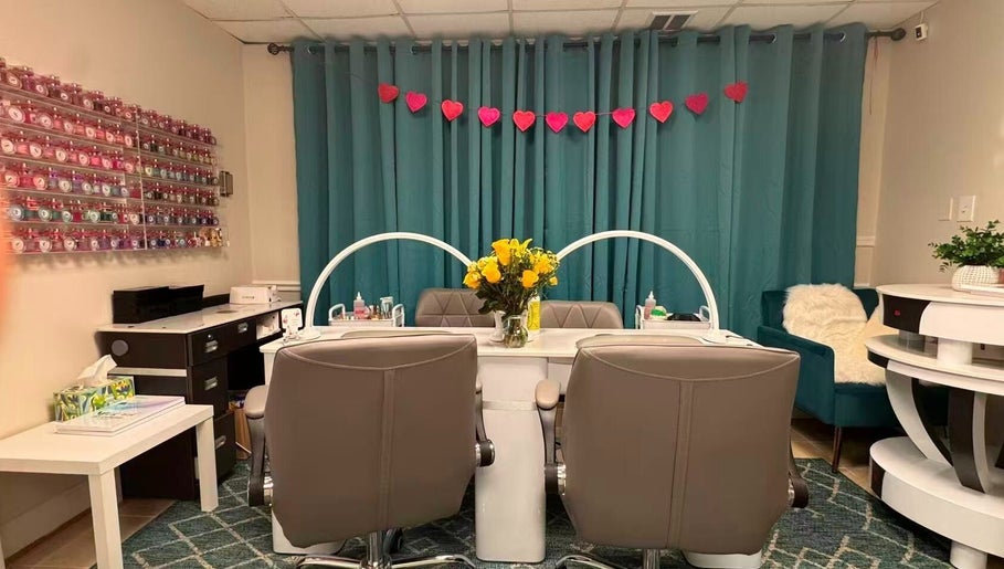 Chic nail station at Unique Nails & Head Spa, Fairfax, Virginia, US, featuring cozy chairs and vibrant decor.