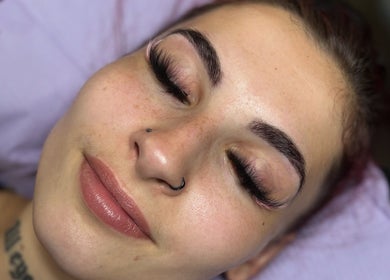 Client with enhanced lashes at Pretty Girls Aesthetics, Buffalo, New York, US enjoying beauty treatment.