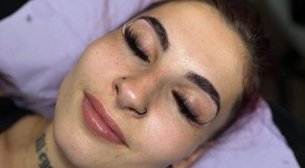 Client with enhanced lashes at Pretty Girls Aesthetics, Buffalo, New York, US enjoying beauty treatment.