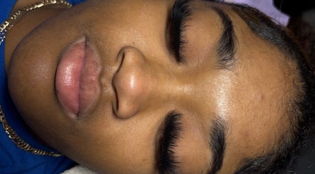 Client showcases exquisite eyelash extensions at Pretty Girls Aesthetics, Buffalo, New York, US spa.