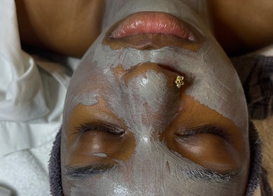 Relaxing facial treatment at Pretty Girls Aesthetics, Buffalo, NY, US, showcasing a rejuvenating mask application.