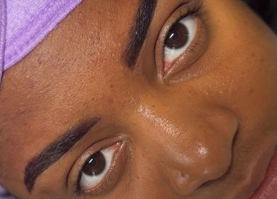 Close-up of radiant skin and perfectly arched brows at Pretty Girls Aesthetics in Buffalo, NY, US.