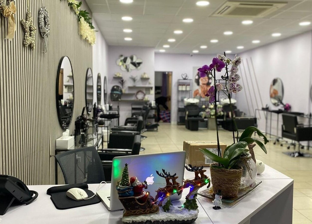 Modern interior of Muna Salon 2 in Borehamwood, England, GB, featuring chic decor and styling stations.