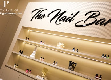 Elegant nail bar at Pretty Parlor Salon, Dubai, Dubai, AE featuring stylish shelves with nail products.