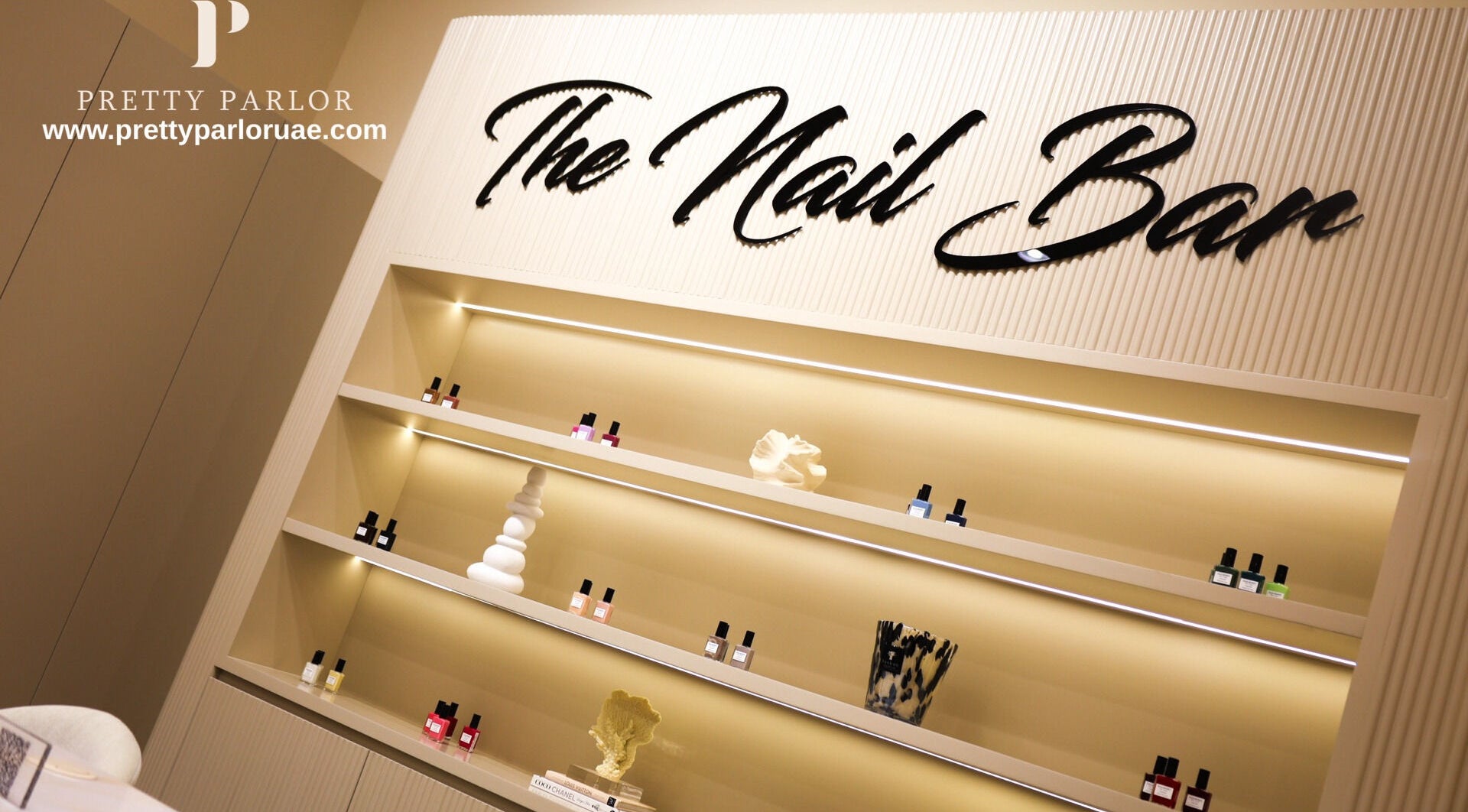Elegant nail bar at Pretty Parlor Salon, Dubai, Dubai, AE featuring stylish shelves with nail products.