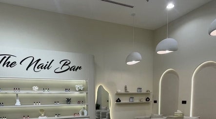 Elegant nail bar at Pretty Parlor Salon, Dubai, Dubai, AE. Features sleek shelves with nail polish and modern decor.