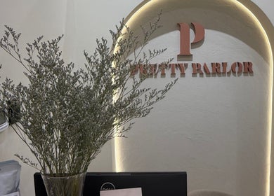 Pretty Parlor Salon reception in Dubai, Dubai, AE with stylish floral decor and elegant signage.