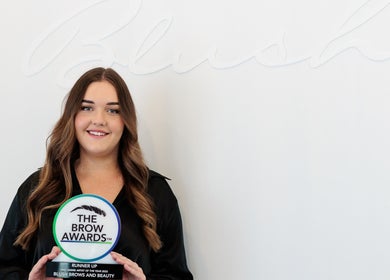 Award winner at Blush Brows + Beauty, North Mackay, Queensland, AU, holding The Brow Awards plaque.