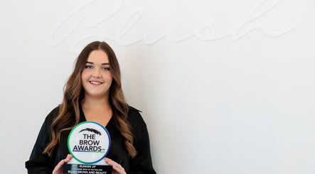 Award winner at Blush Brows + Beauty, North Mackay, Queensland, AU, holding The Brow Awards plaque.