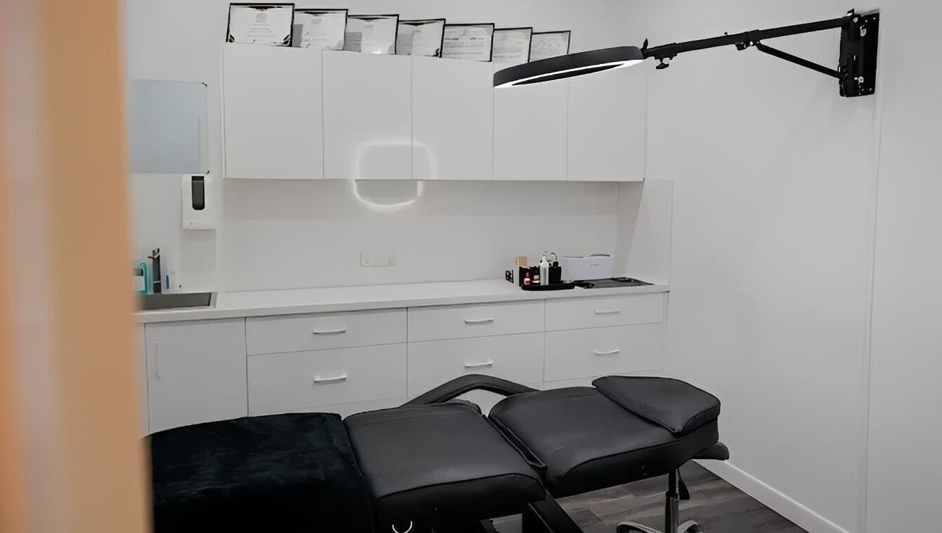 Modern treatment room at Blush Brows + Beauty in North Mackay, Queensland, AU with sleek white cabinetry.