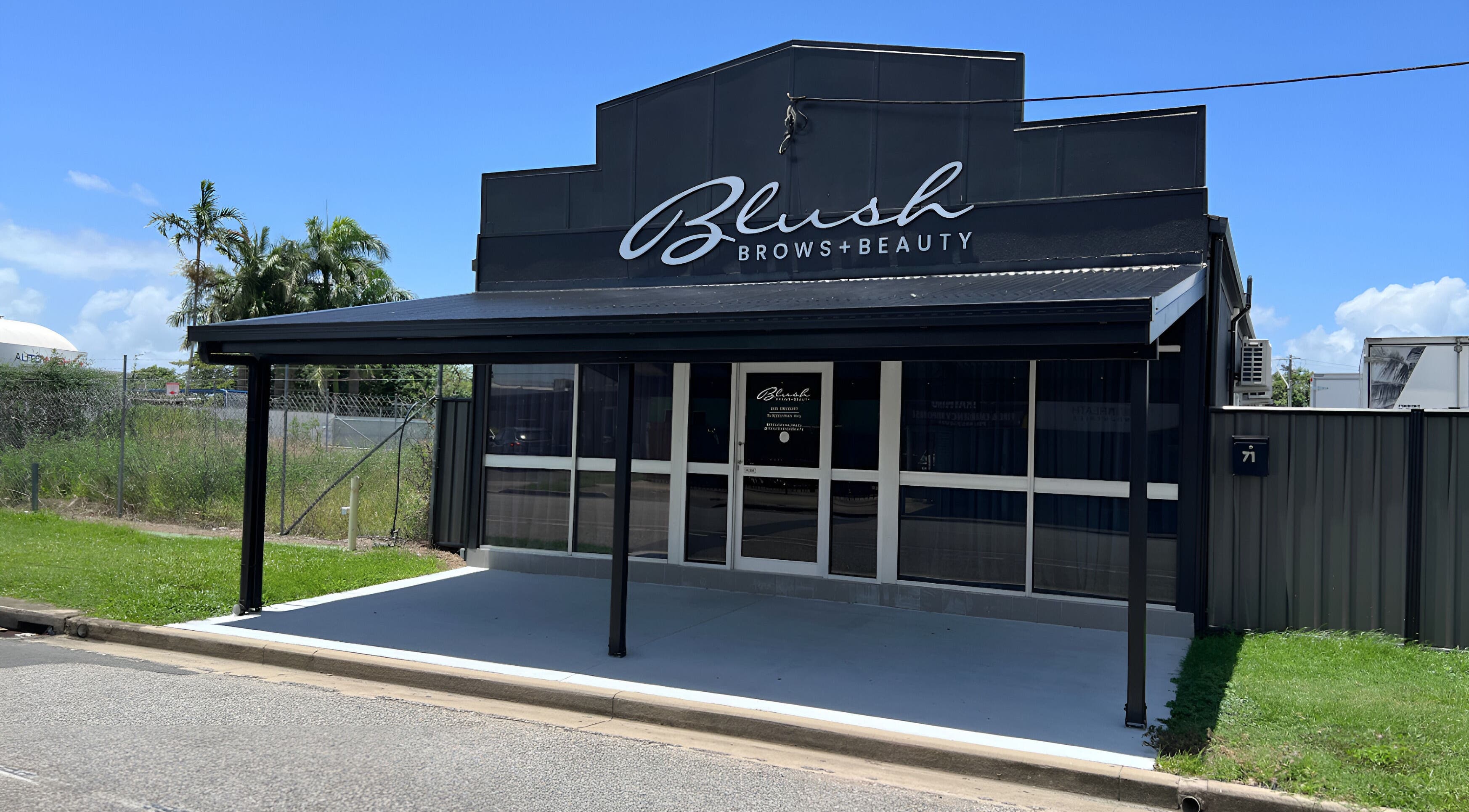 Entrance of Blush Brows + Beauty in North Mackay, Queensland, AU with a modern black exterior.