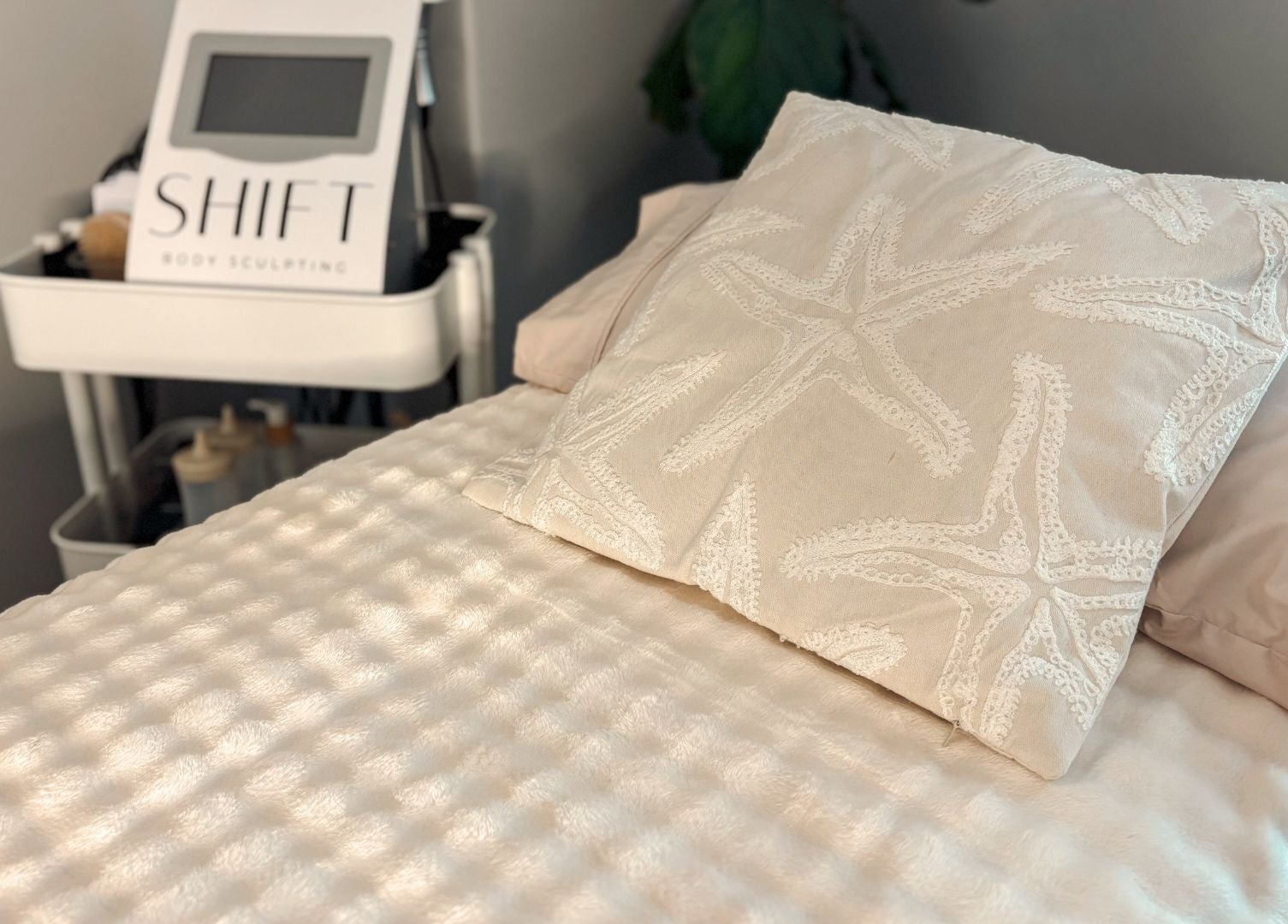 Cozy treatment bed at SHIFT Body Sculpting in Waikiki, Western Australia, AU, with relaxing starfish pillow.