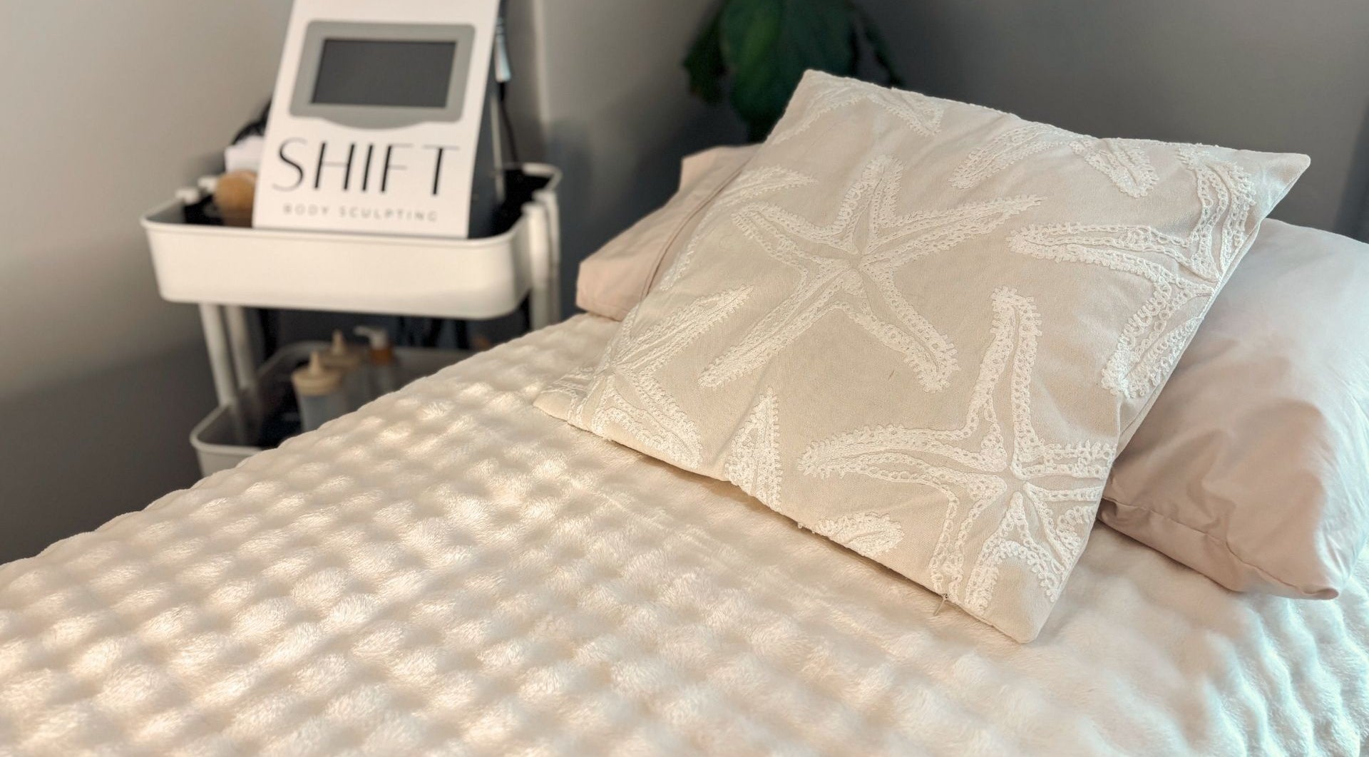 Cozy treatment bed at SHIFT Body Sculpting in Waikiki, Western Australia, AU, with relaxing starfish pillow.
