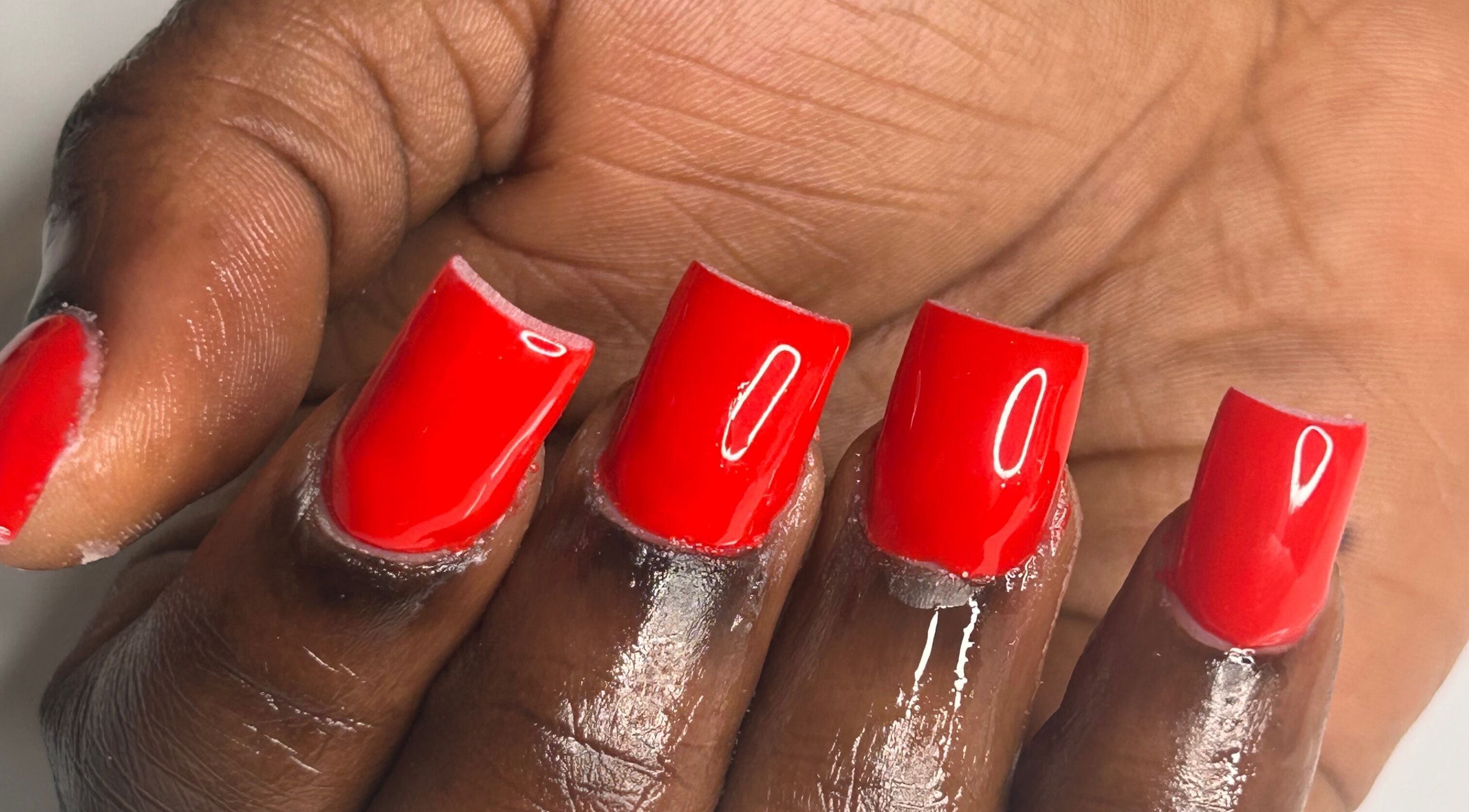 Bold red manicure at Nailsbylamie in Luton, England, GB, showcasing glossy square-shaped nails.