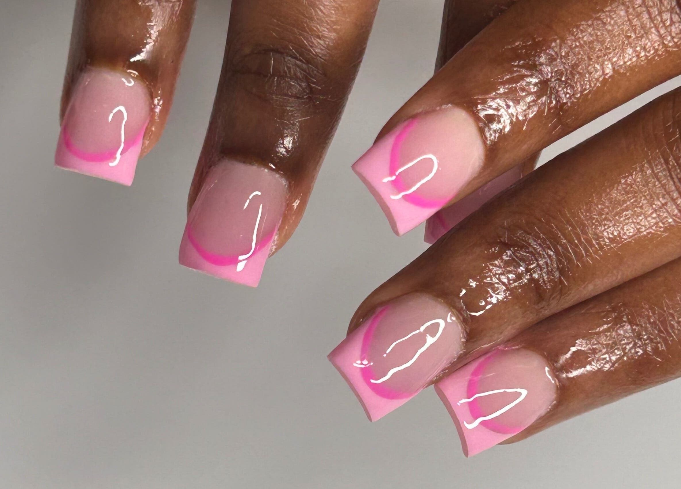 Pink French tips manicure at Nailsbylamie, Luton, England, GB, showcasing gloss and precision.